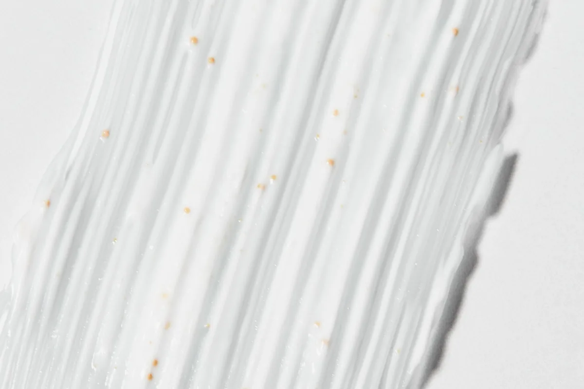 A swatch of white cream on a pale surface.